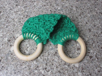 A handmade Kitchen towel Holder made of 100% Cotton Yarn in Bright  Green Color with two cream-colored wooden rings, shown on a speckled gray countertop.