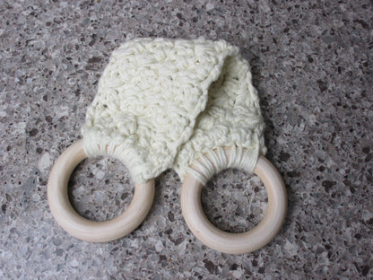 A handmade Kitchen towel Holder made of 100% Cotton Yarn in Ivory Color with two cream-colored wooden rings, shown on a speckled gray countertop.