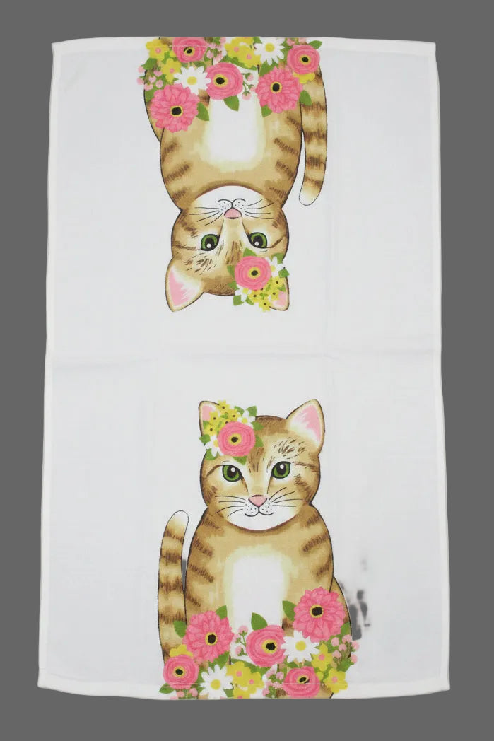 Towel fully opened featuring two cartoon tabby cats with pink flower crowns and colorful floral arrangements, laid out on a gray surface.